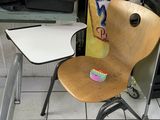 a chair and a table in a room with a sign on the wall