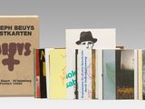 a lot of books that are stacked on top of each other
