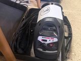 un aspirateur noir et blanc posé par terre à côté d'autres objets