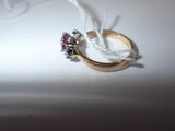 a gold ring with a red and blue stone on it