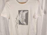 white t - shirt with a butterfly on it on a hanger in front of a curtain