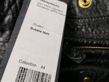 an image of a close up of a black purse with a label on it