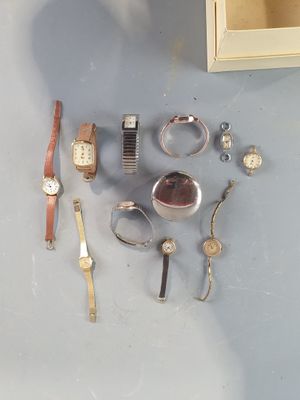 a lot of different watches and bracelets on the table
