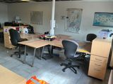 an image of a work space with a desk and chairs
