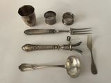 a lot of silverware on a table with spoons and forks