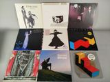 various vinyl albums are arranged on a table in front of a white background