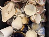 a lot of cups and saucers in a box