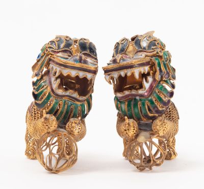 pair of gold and enamel foo foo foo figurines on wheels
