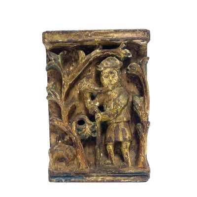 une sculpture en bois représentant un homme tenant un oiseau dans la main