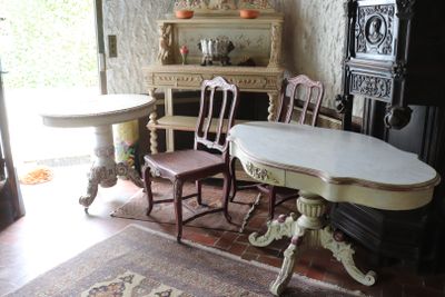 a table and chairs in a room with a rug on the floor