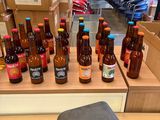 many bottles of beer sitting on a table in a store