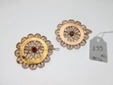 a pair of gold and garnetite earrings