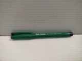 a green pen sitting on top of a white box