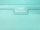 the inside of a blue purse with the name hermes on it