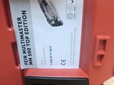 a red box with a black handle that has a paper in it