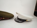 two hats are sitting next to each other on a white surface