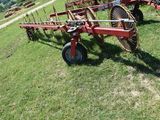 a red tractor that is sitting in the grass