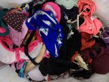 a pile of clothes that is on a bed
