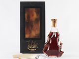 a bottle of liquor sitting next to a glass of wine