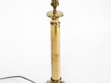 an antique brass table lamp on a white background