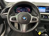 the interior of a car with a steering wheel and dashboard controls