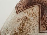 a brown and white vase with a design on it