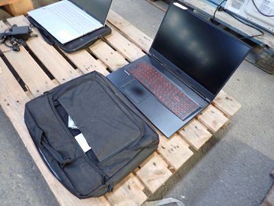 a laptop computer sitting on top of a wooden pallet