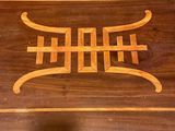 a wooden table with a decorative design on it