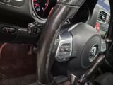 a steering wheel and dashboard of a car in a car showroom