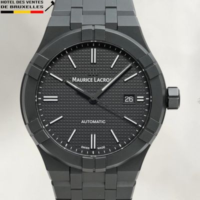 a close up of a watch with a black face on a white background