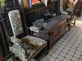 two chairs and a table in a room with wallpaper