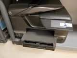 a printer sitting on top of a desk next to a printer