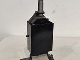 an old black metal stove sitting on top of a white table