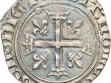 a close up of a coin with a cross on it