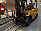 a forklift truck that is parked in a warehouse