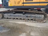 a picture of a yellow and black bulldozer parked in a parking lot