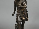 bronze statue of a boy with a bird on his shoulder