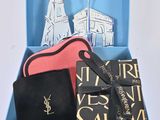 a blue box with a black purse and a pink purse in it