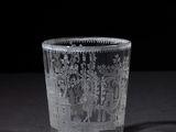a glass cup with a pattern on it on a table