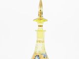 yellow glass perfume bottle with a gold top on a white background
