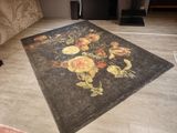 a rug with a floral design on it in the middle of a living room