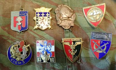 a lot of badges that are on a military uniform