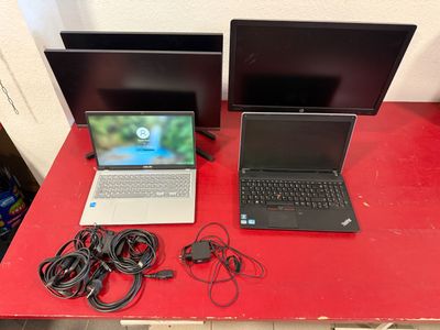 two laptops that are sitting on a red table