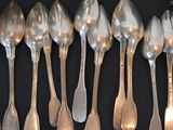 a lot of spoons that are lined up on a table