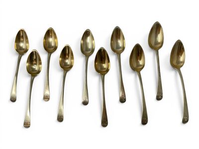 six spoons are lined up in a row on a white surface