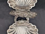 a close up of a silver plate with a bird on it