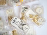 many different types of jewelry in plastic containers on the table