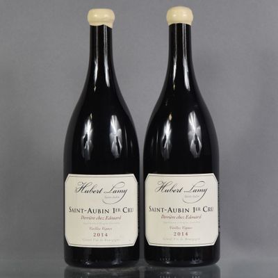 two bottles of wine sitting next to each other on a table