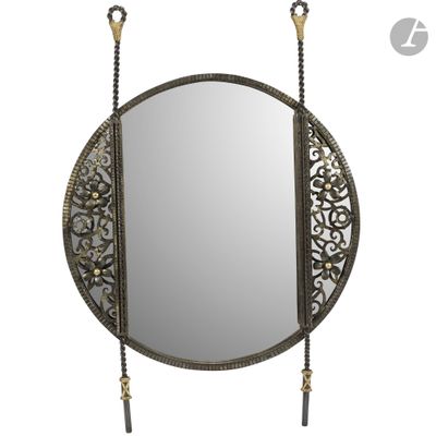 an image of a round mirror with a chain hanging from it