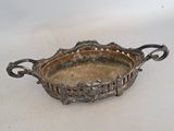 a silver tray with a handle on a white surface